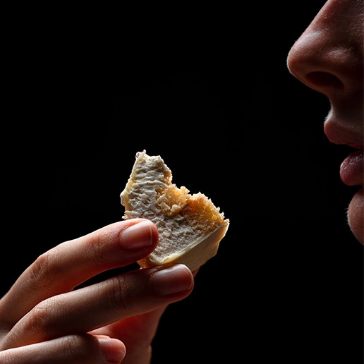 Woman enjoying a bite at Dans le Noir ? restaurant