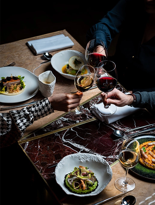 A group of guests celebrating a farewell over a gourmet dinner at the Dans le Noir ? restaurant